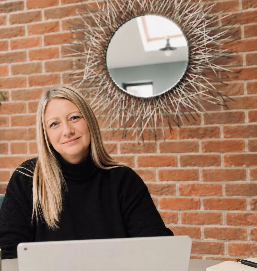 Natalie, founder of SCOUT & JEM, sitting at a desk